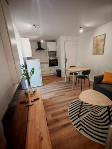 a living room with a couch and a table at Appartements à Evron in Évron