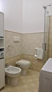 a bathroom with a toilet and a sink and a shower at Holiday in Paradise in Balestrate