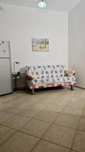 a couch in the corner of a room at Holiday in Paradise in Balestrate