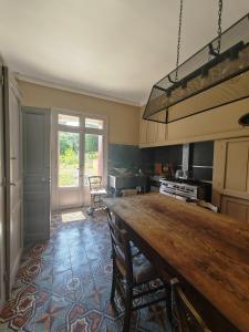 a kitchen with a large wooden table in a room at Rosemar in Peyriac-de-Mer