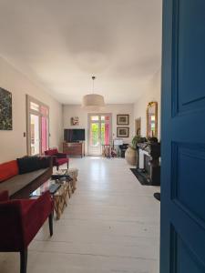 a living room with couches and a living room with a table at Rosemar in Peyriac-de-Mer +26 photos