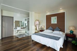 a bedroom with a large bed and a bathroom at Seaward in Koror