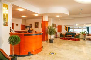 an office lobby with a reception desk and chairs at Hotel Makpetrol Struga in Struga +26 photos