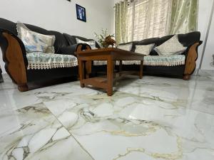 a living room with a couch and a table at SS Hostel in Siliguri
