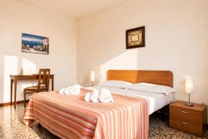 a hotel room with a bed with towels on it at Apartment Alex 1 in Domaso in Domaso