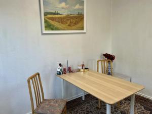 a dining room table with two chairs and a picture on the wall at FBC Roms Business in Rødby +37 photos