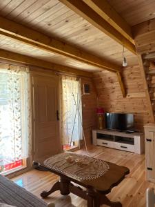 a living room with a table and a tv at Apartman Boro in Žabljak