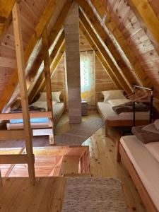 a bedroom in a log cabin with two bunk beds at Apartman Boro in Žabljak