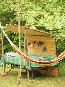 a hammock in front of a bird house at Glamping Tent Celte du Morvan, Vrij in de Natuur in La Tagnière +6 photos