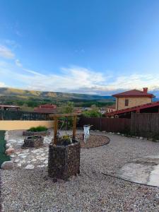 a garden with a wooden table and a fence at El Torreón in Valderredible