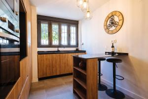 a kitchen with a sink and a bar with a stool at Luis Montoto in Seville