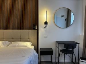 a bedroom with a bed and a mirror and a stool at Lumen - Bright Stay in Bucharest in Bucharest