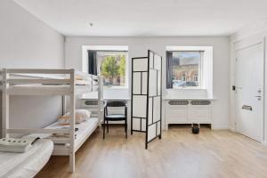 a room with two bunk beds and a desk at John F Kennedys Suite in Aalborg