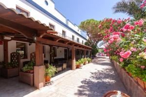 a street with flowers and plants on the side of a building at Hotel Stella Del Sud in Calasetta