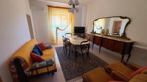 a living room with a table and a mirror at La casa di nonna Gianna in Gonnesa