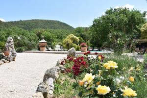 a garden with flowers and rocks in a park at Casa Jasmine by Lisetta in Migiana