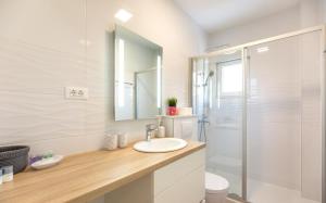 a bathroom with a sink and a shower at Ksenija Apartments in Tučepi +40 photos