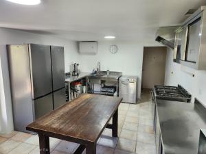a large kitchen with a wooden table in it at Grand Gite des Jourdets in Lairière +25 photos
