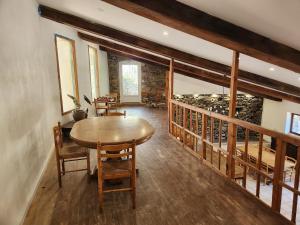 a room with a table and chairs and a wine cellar at Grand Gite des Jourdets in Lairière