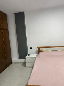 a bedroom with a bed and a dresser next to a door at AirbnbTzo in Perístasis