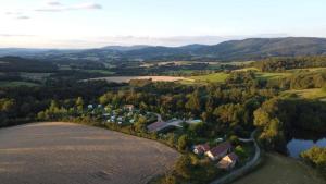 an aerial view of a house in a field next to a lake at Glamping Tent Celte du Morvan, Vrij in de Natuur in La Tagnière