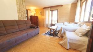 a living room with a couch and a table at La Staulette in Queige