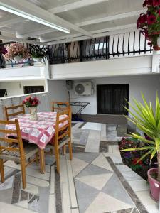 a dining room with a table and chairs on a patio at AirbnbTzo in Perístasis