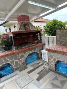 an outdoor brick pizza oven on a patio at AirbnbTzo in Perístasis