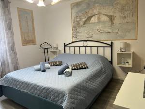 a bedroom with a bed with blue pillows on it at Rooms Barbieri Rovinj in Rovinj