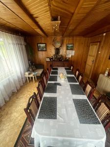 a large long table in a room with chairs at Domek Pod Skansenem in Białowieża