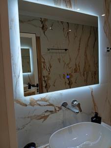 a bathroom with a sink and a mirror at Milto's Rooms in Himare +64 photos