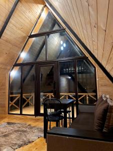 a living room with a table and a large window at Сади Вітрів in Oriv