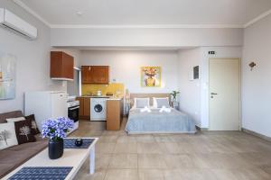 a large room with a bed and a kitchen at Nefeli Rooms in Agia Marina Nea Kydonias