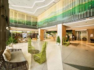 a lobby with chairs and tables in a building at ibis Styles Nha Trang in Nha Trang