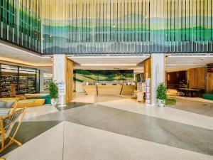 a lobby of a building with tables and chairs at ibis Styles Nha Trang in Nha Trang