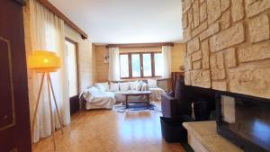 a living room with a couch and a fireplace at La Staulette in Queige