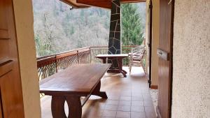 a wooden table on the balcony of a house at La Staulette in Queige