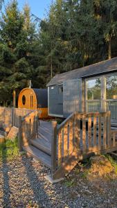 a wooden ramp leading to a trailer with a house at Maringotka u lesa in Staňkovice