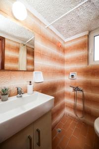 a bathroom with a sink and a shower at Nefeli Rooms in Agia Marina Nea Kydonias +66 photos