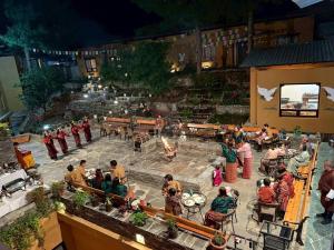 a group of people standing around a patio with a fire pit at Haven Resort Paro in Paro