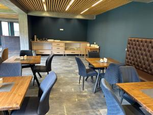a dining room with wooden tables and chairs at Hotel Mansarda Mestia in Mestia +56 photos