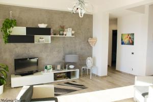 - un salon avec une télévision et un canapé dans l'établissement Villa Cecilia, à Montallegro