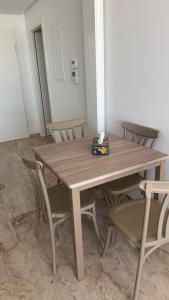 a wooden table with chairs and a box on it at Penthouse sarra in Kelibia +13 photos