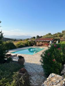 a swimming pool in a yard with a house at The Englishman's Villa Evia in Perivólia