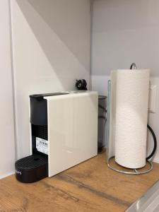 a roll of paper towels next to a microwave at City Apartment in Lörrach