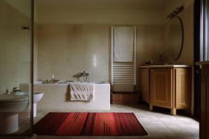 a bathroom with a tub and a sink and a toilet at The Englishman's Villa Evia in Perivólia +16 photos