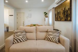 a living room with a couch with zebra pillows at Luis Montoto in Seville