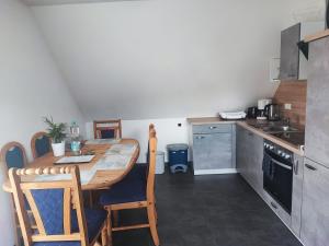 a small kitchen with a wooden table in a room at Ferienwohnung Mühlbach in Igensdorf