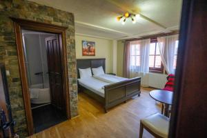 a bedroom with a bed and a bathroom at Luxury Villa Medusa Temple in Kruševo