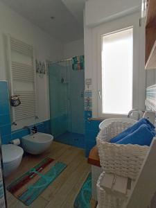 a bathroom with two sinks and a glass shower at A Casa Di Dona in Rimini +15 photos